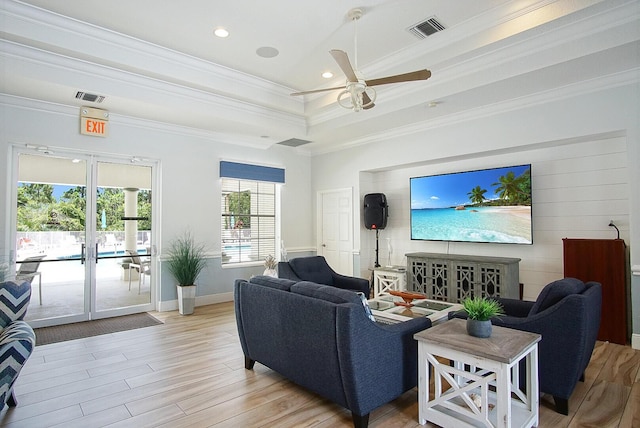 living room with ceiling fan, light hardwood / wood-style floors, ornamental molding, and french doors