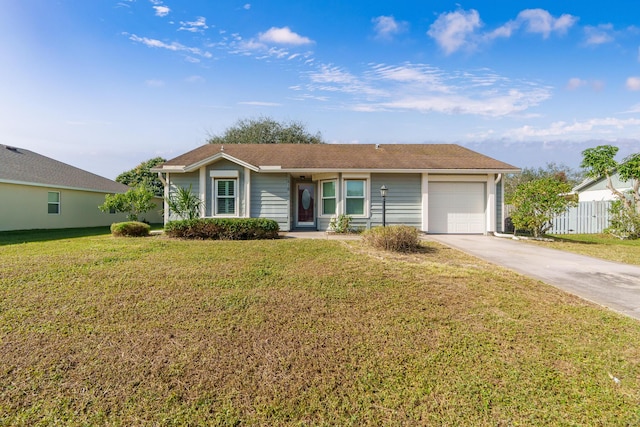 ranch-style home featuring a garage and a front lawn