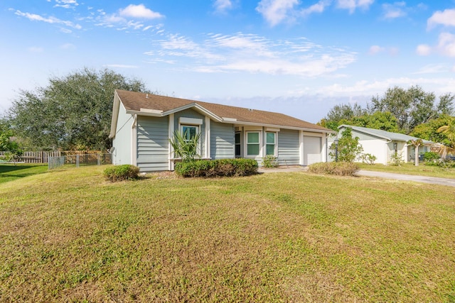 ranch-style home with a front yard and a garage