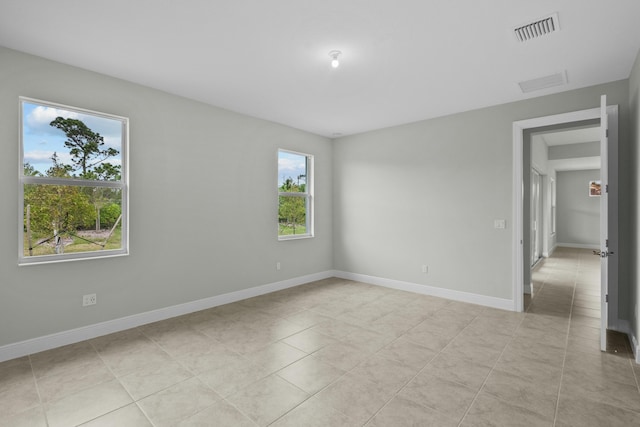 spare room featuring light tile patterned floors