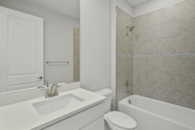 full bathroom featuring vanity, toilet, and tiled shower / bath