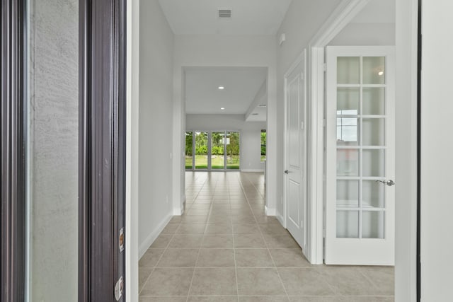 hall featuring light tile patterned floors