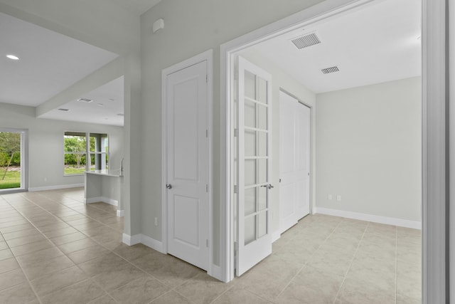 hall featuring light tile patterned floors