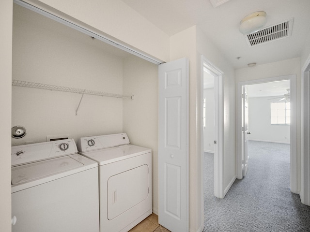 laundry area with light carpet, washer and clothes dryer, and ceiling fan