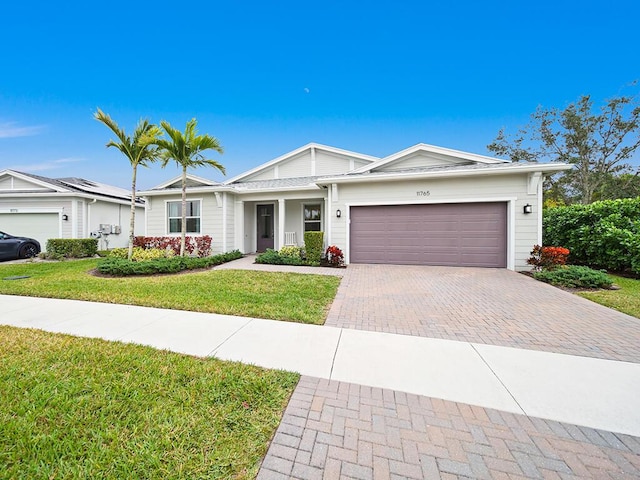 single story home featuring a garage and a front yard