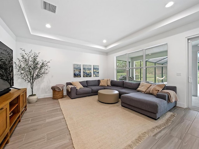 living room with a tray ceiling