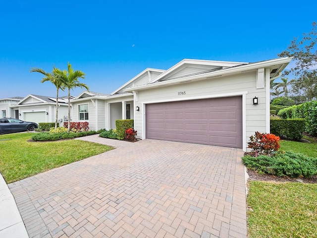 single story home featuring a garage and a front lawn