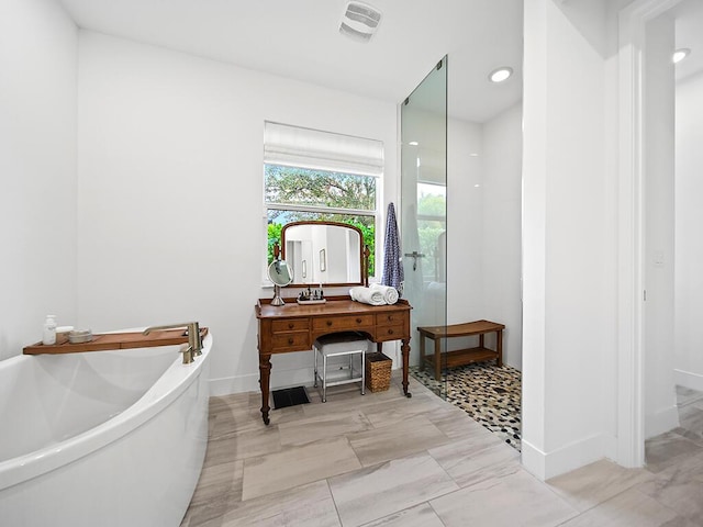 bathroom featuring separate shower and tub