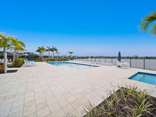 view of swimming pool with a patio area and a hot tub