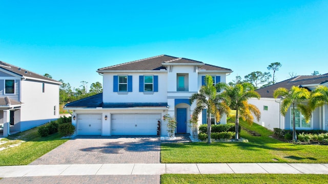 view of front of house with a front lawn and a garage