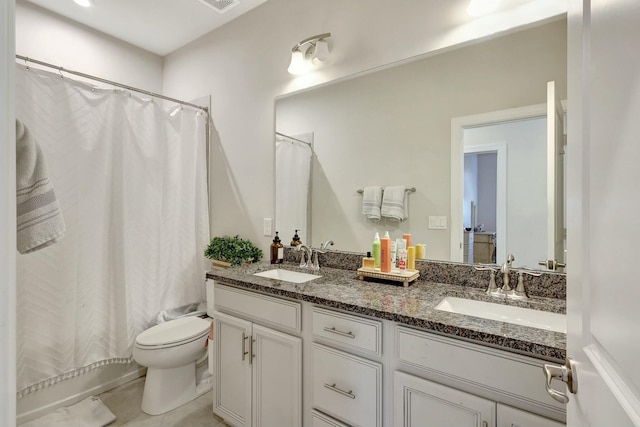 full bathroom featuring tile patterned floors, shower / bathtub combination with curtain, vanity, and toilet