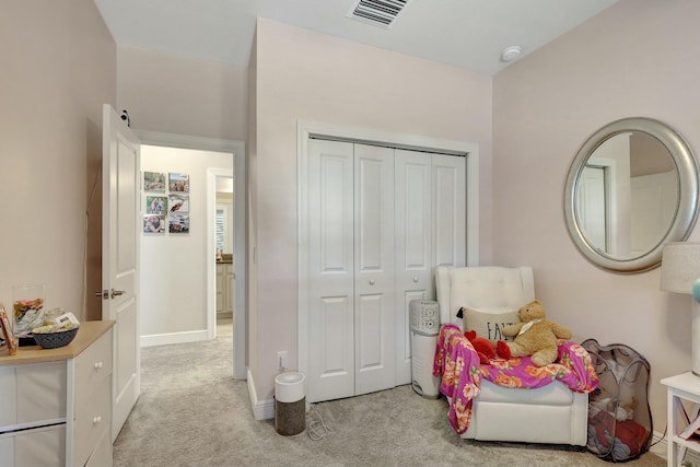 bedroom featuring a closet and light colored carpet