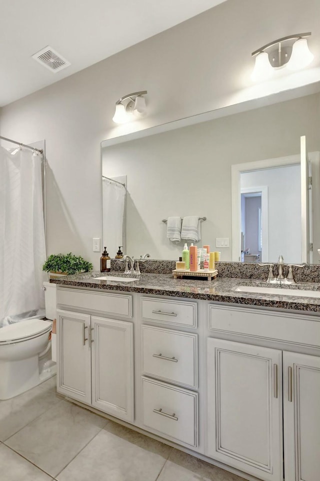 bathroom with tile patterned flooring, a shower with curtain, and vanity