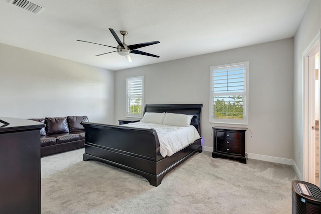 bedroom with light colored carpet and ceiling fan