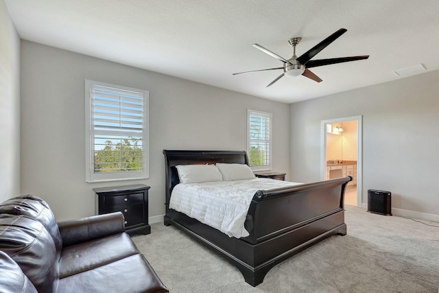 carpeted bedroom with ceiling fan and connected bathroom