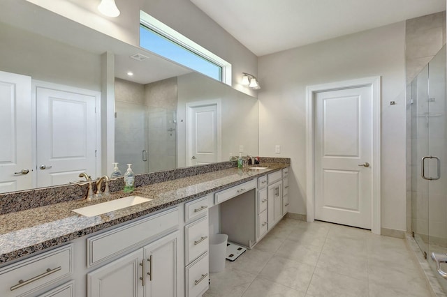 bathroom with tile patterned floors, vanity, and an enclosed shower