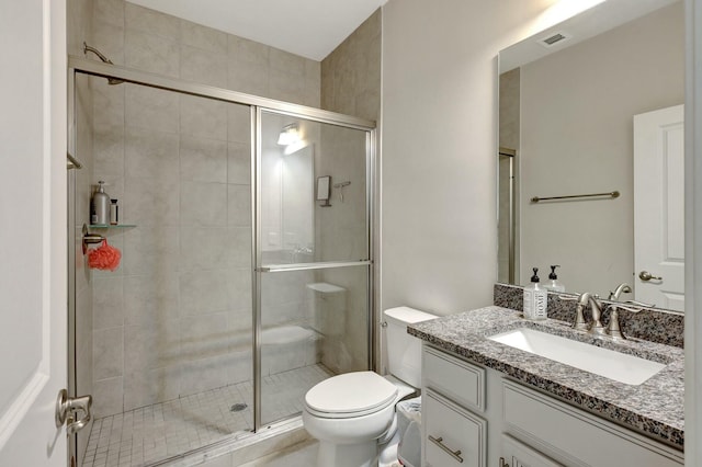 bathroom with vanity, toilet, and walk in shower