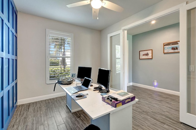 office with dark hardwood / wood-style floors and ceiling fan