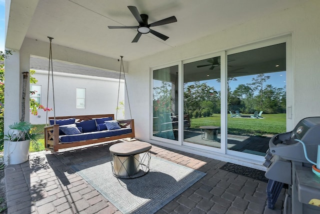 view of patio featuring a grill, ceiling fan, and an outdoor living space