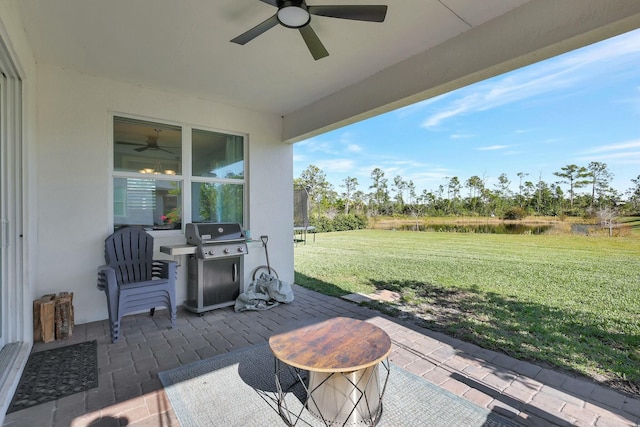 view of patio featuring a trampoline, area for grilling, and ceiling fan