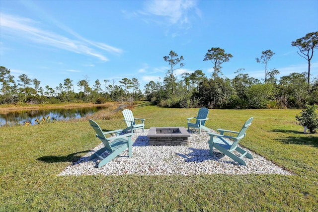 view of yard with a water view and a fire pit