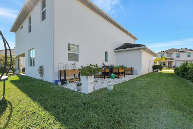 rear view of house featuring a lawn