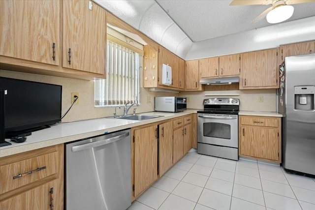 kitchen featuring ceiling fan, sink, stainless steel appliances, a textured ceiling, and light tile patterned floors