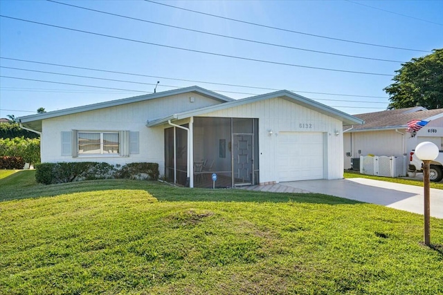 single story home with a garage, a front lawn, and a sunroom