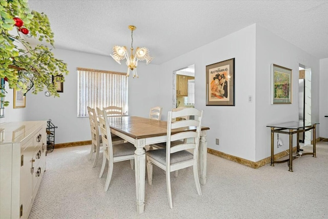 dining space with a textured ceiling and a chandelier