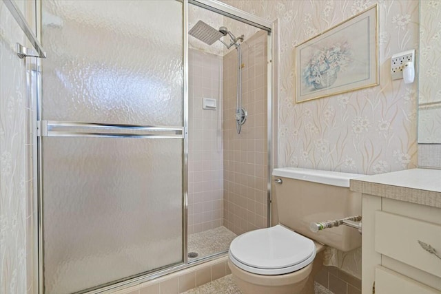 bathroom with vanity, toilet, and a shower with shower door