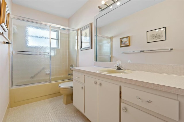 full bathroom with tile patterned flooring, vanity, toilet, and combined bath / shower with glass door