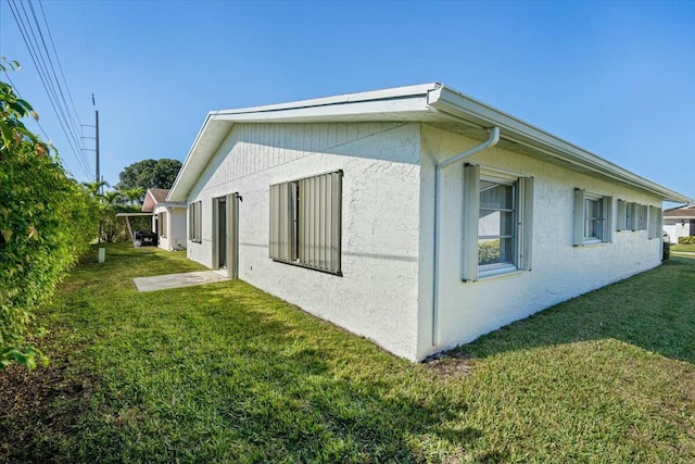 view of home's exterior with a yard