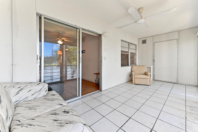 interior space with ceiling fan