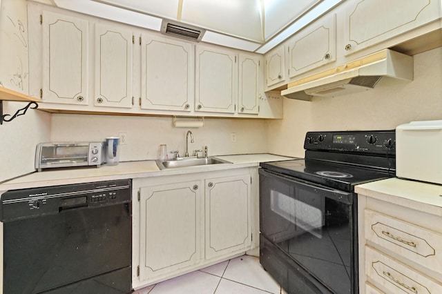 kitchen with light tile patterned floors, sink, and black appliances