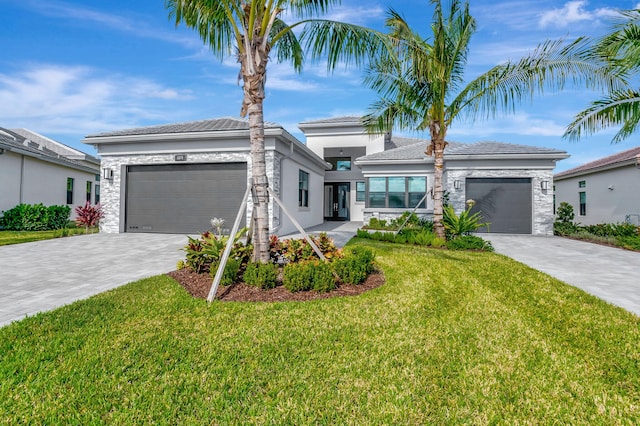 view of front of house featuring a garage and a front lawn