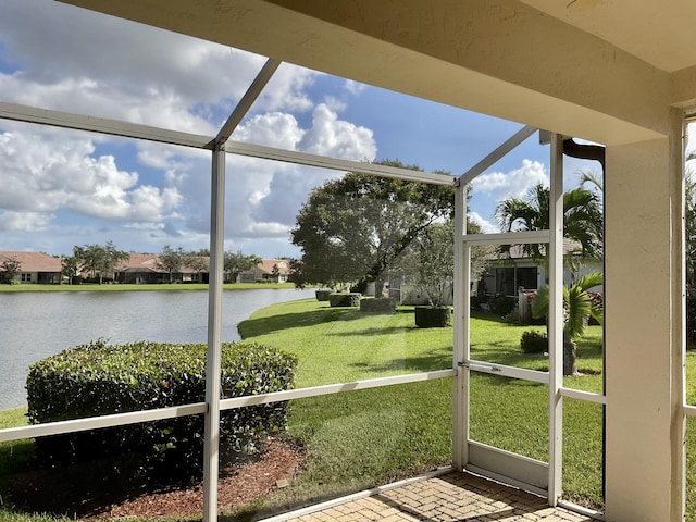 unfurnished sunroom with a water view