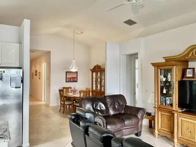 tiled living room featuring ceiling fan and lofted ceiling