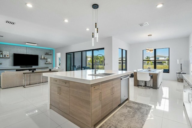 kitchen featuring a large island, light tile patterned flooring, and decorative light fixtures