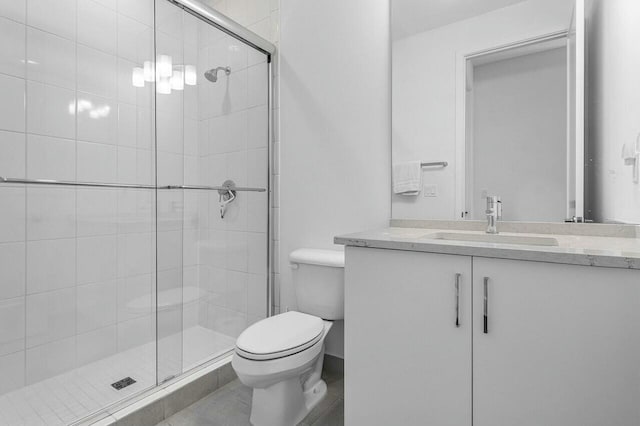 bathroom featuring vanity, toilet, and walk in shower