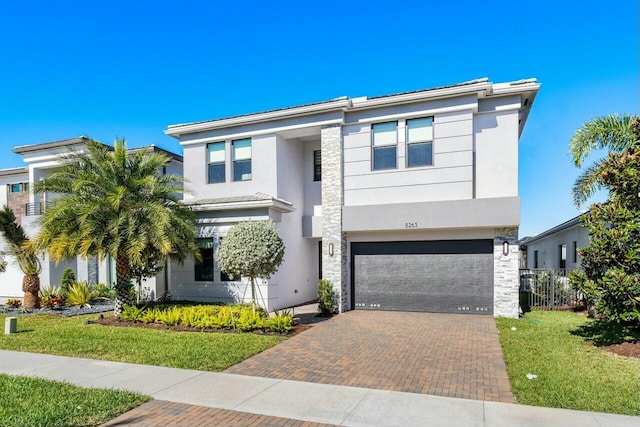 view of front of house with a garage and a front lawn