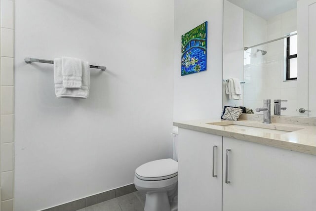 bathroom with tiled shower, vanity, toilet, and tile patterned flooring