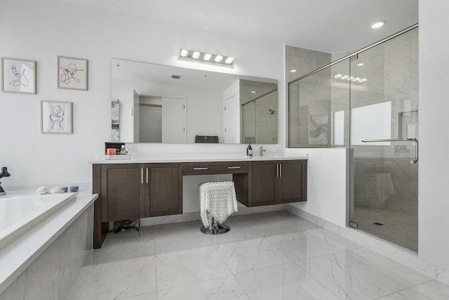 bathroom with vanity and separate shower and tub