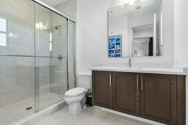 bathroom with vanity, a shower with shower door, and toilet