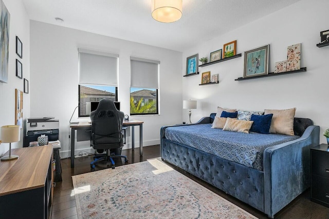 bedroom with dark hardwood / wood-style floors