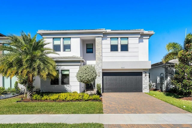 view of front of property with a front yard and a garage