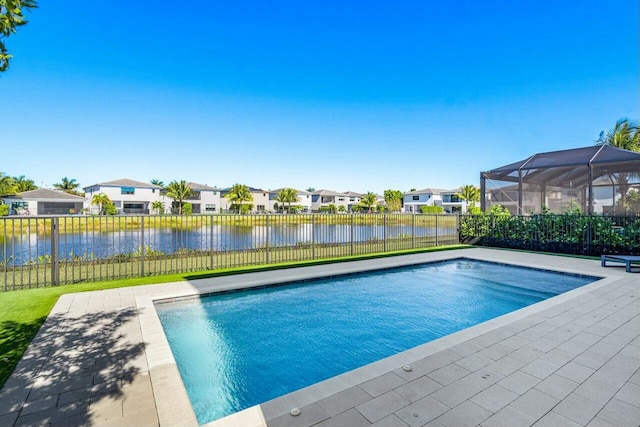 view of pool with a water view and glass enclosure