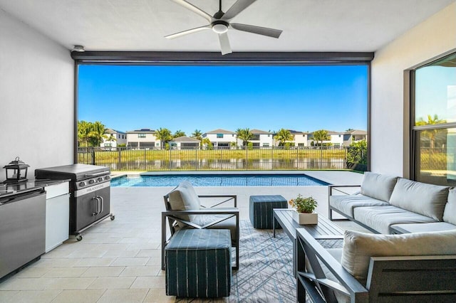 view of patio with an outdoor living space, a water view, ceiling fan, and a fenced in pool