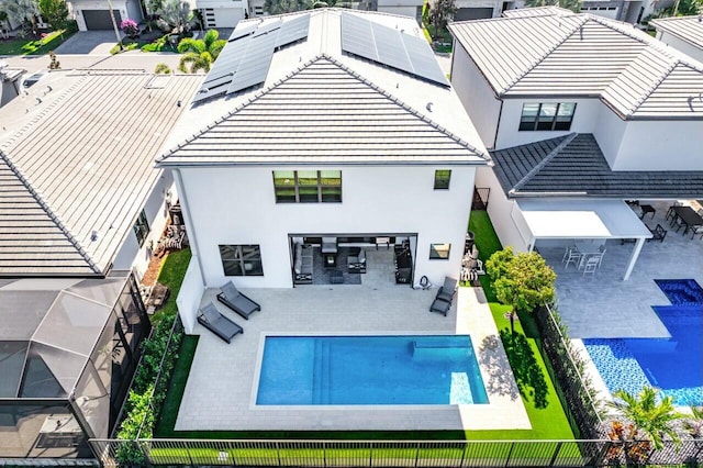 rear view of house featuring solar panels