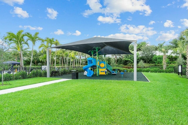 view of playground with a lawn