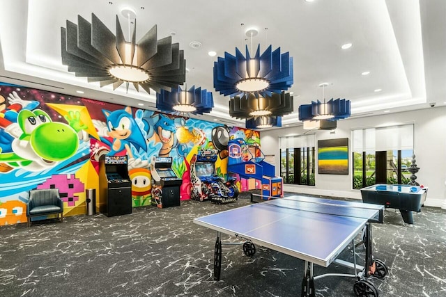 game room with a tray ceiling